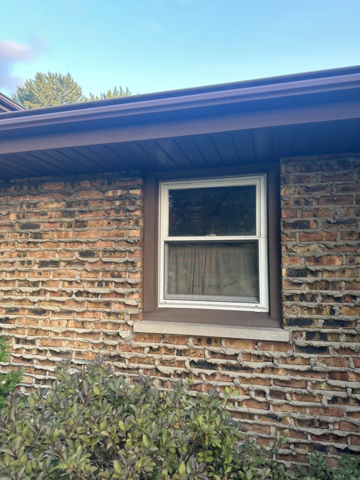 A new brown gutter and soffit installation on a brick home in Joliet, IL