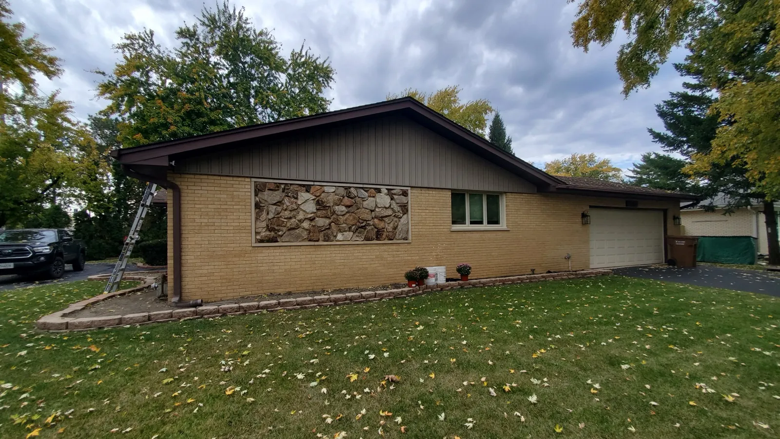 A new asphalt shingle roof on a ranch-style home with brick and stone accents in La Grange, IL
