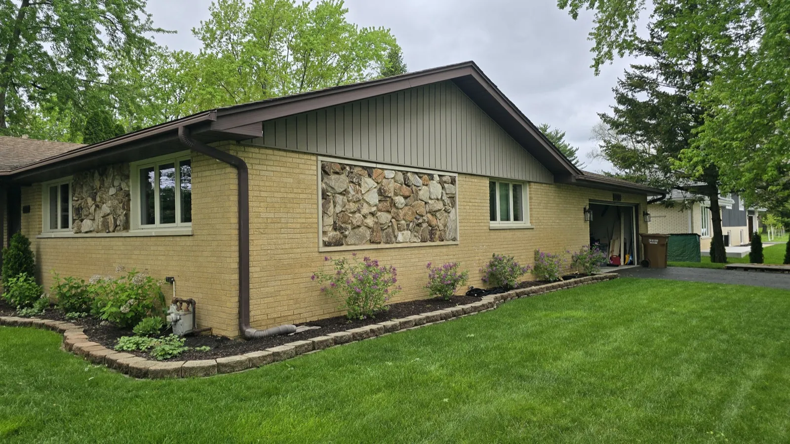 A brown asphalt architectural shingle roof on a brick and stone home in La Grange, IL