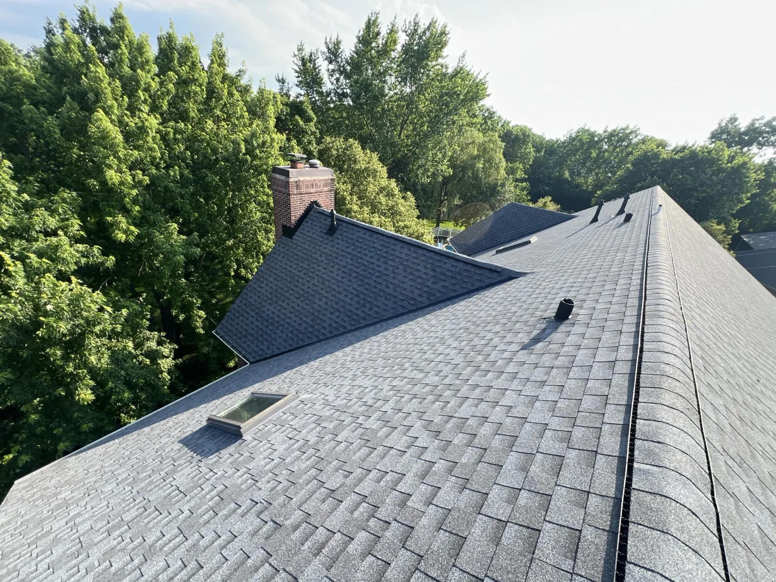 New charcoal gray architectural shingle roof on a multi-gabled home in Lemont, IL