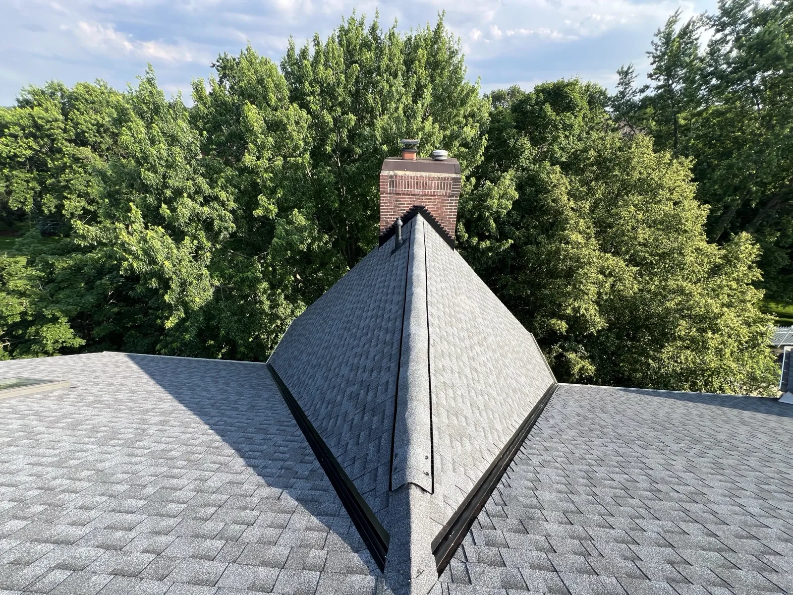 New gray architectural shingle roof with a brick chimney in Lemont, IL