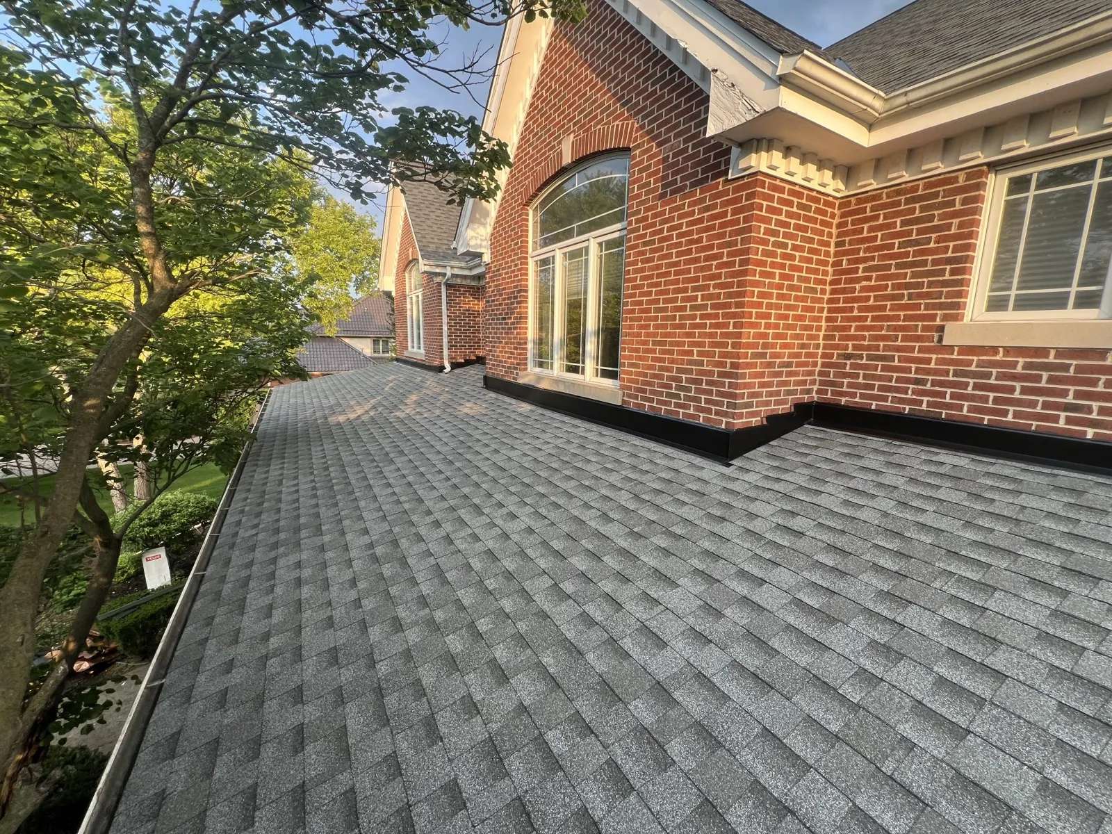New gray architectural shingle roof on a brick home in Lemont, IL