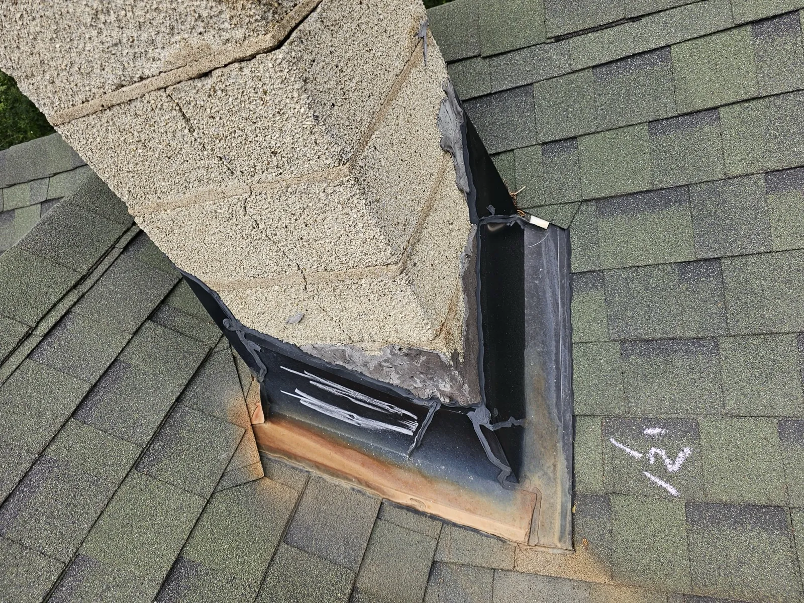 Close-up of a chimney flashing detail on an asphalt shingle roof in Lockport, IL