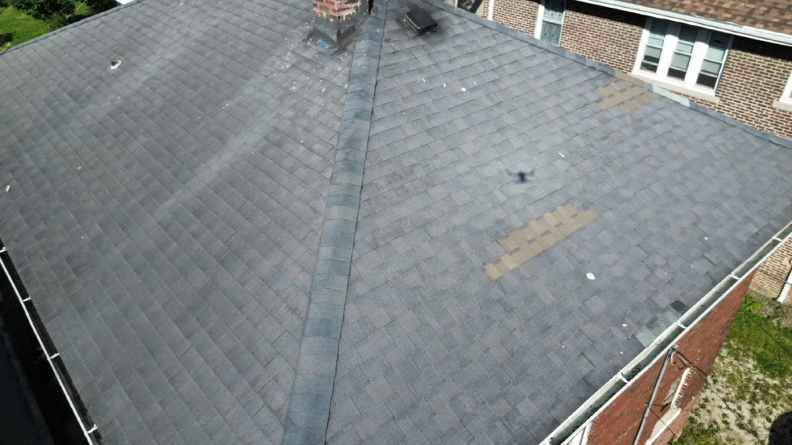 New charcoal gray architectural shingle roof on a brick home in Lockport, IL