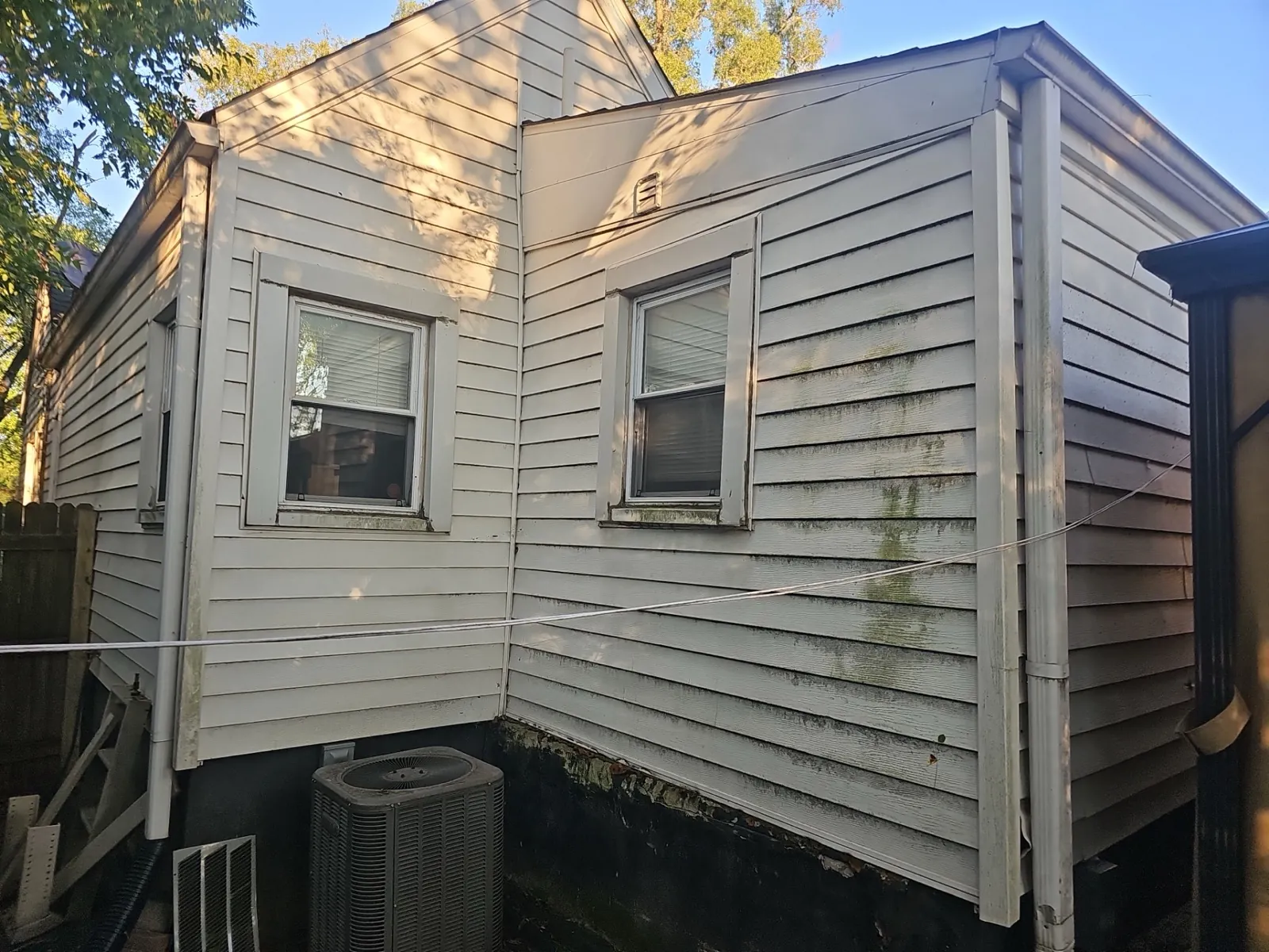White vinyl siding installed on a multi-level home exterior in Lockport, IL
