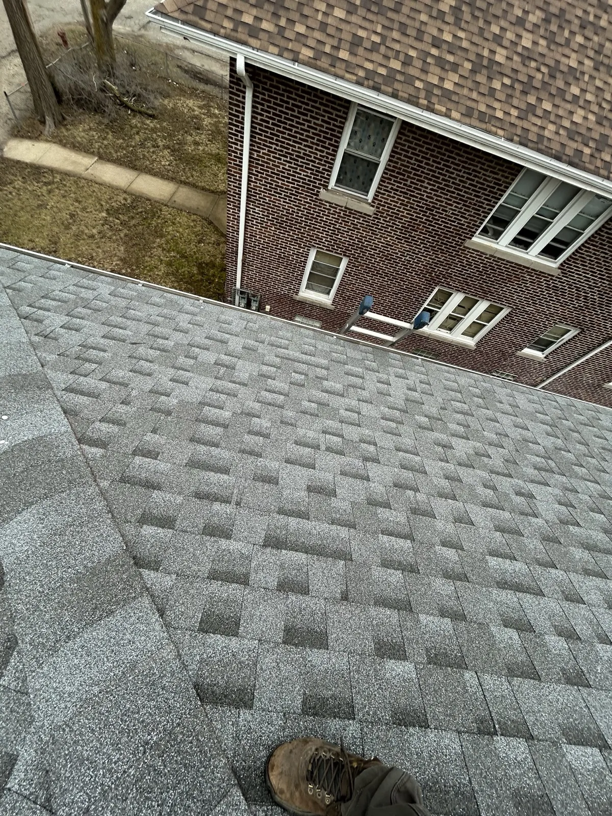 New gray architectural shingle roof on a brick home in Lockport, IL