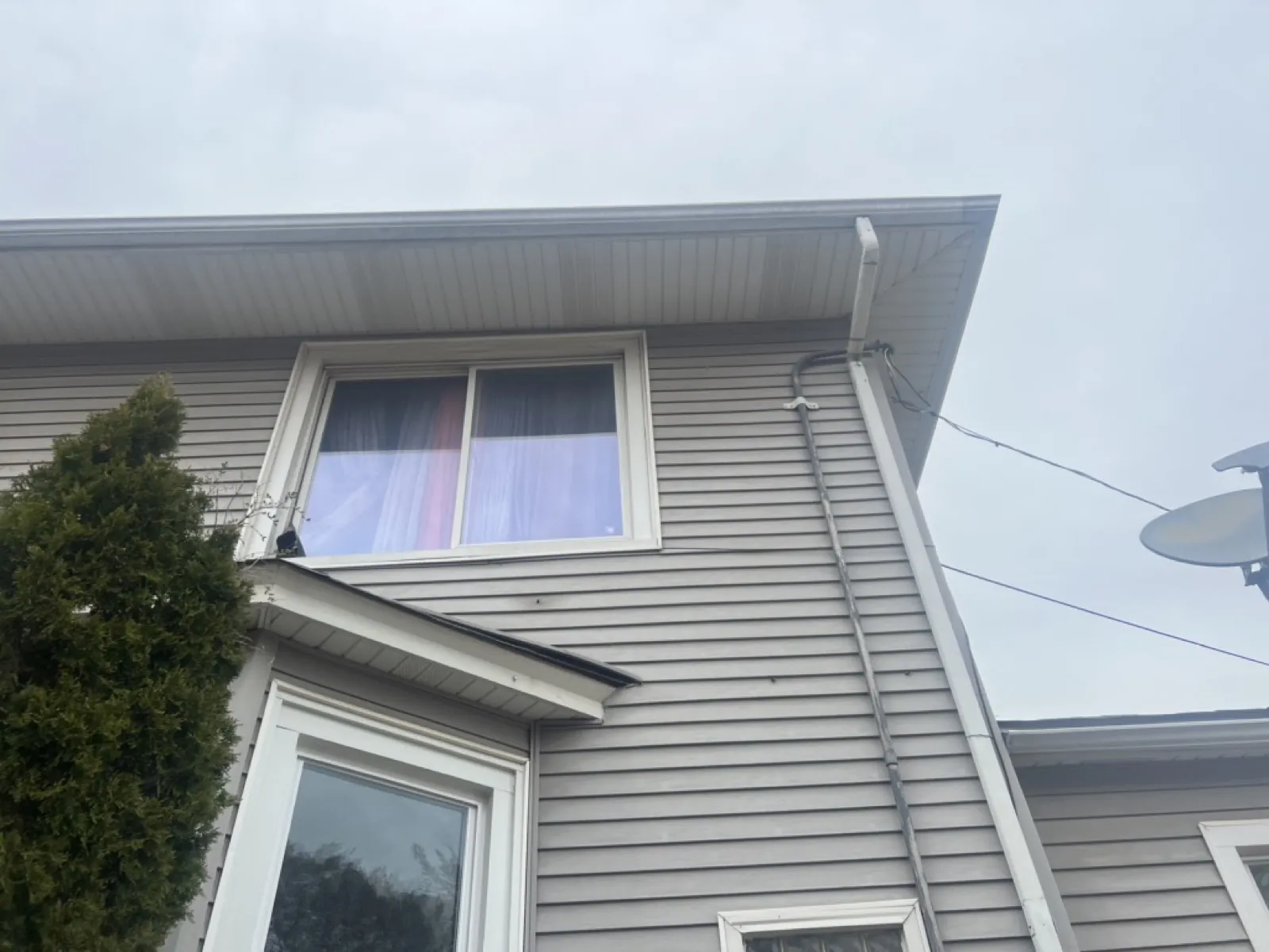 Gray vinyl siding on a two-story home with white trim and gutters in Maywood, IL