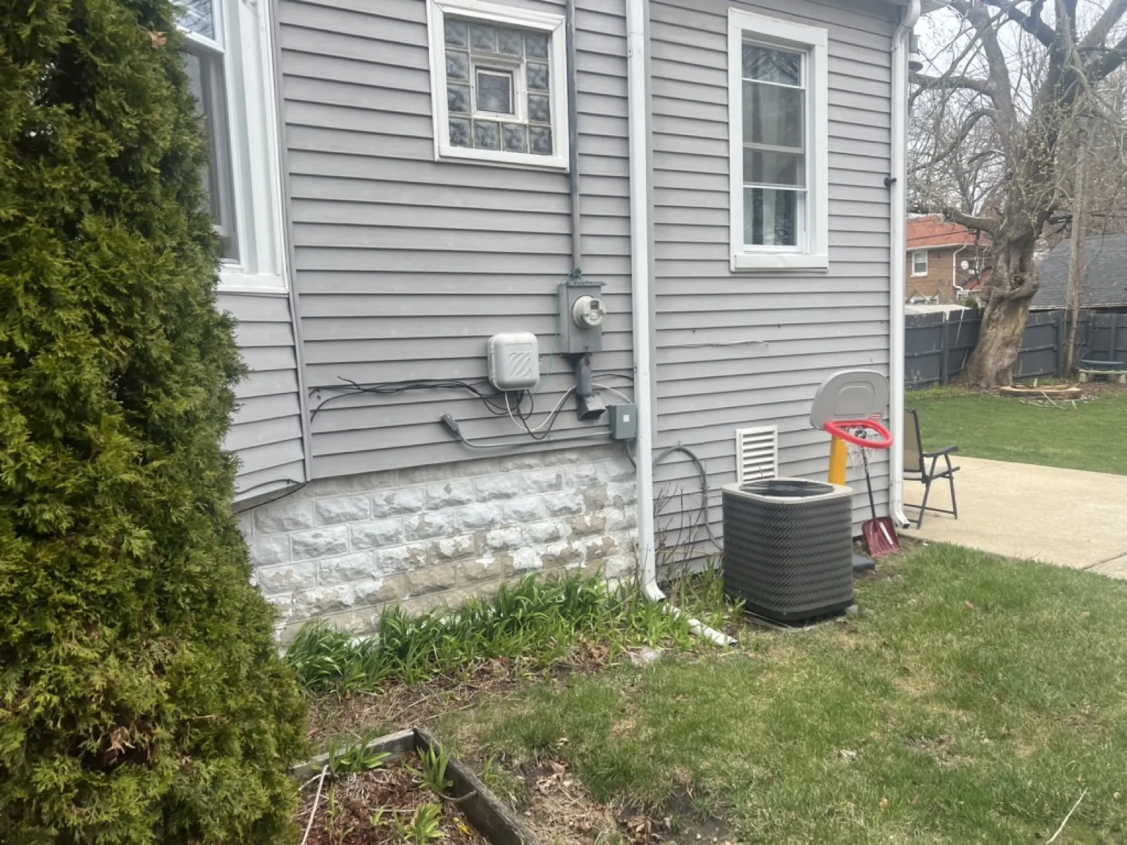 Gray vinyl siding on a residential home with a stone foundation in Maywood, IL