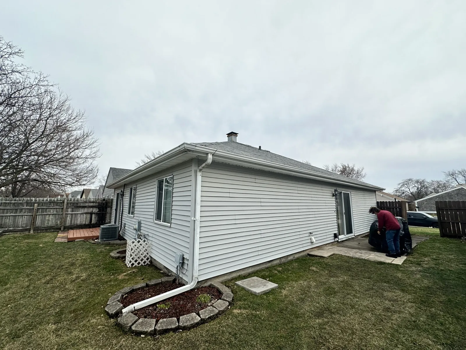 A gray asphalt architectural shingle roof on a single-story home with white siding in Montgomery, IL