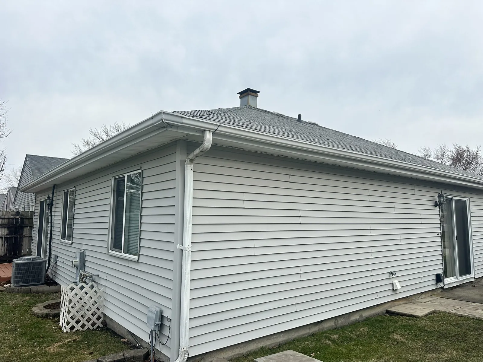 New gray architectural shingle roof on a single-story home with vinyl siding in Montgomery, IL