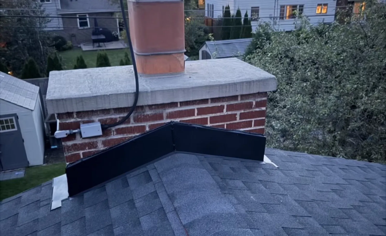 New charcoal architectural shingle roof with a chimney flashing installation in Mount Prospect, IL