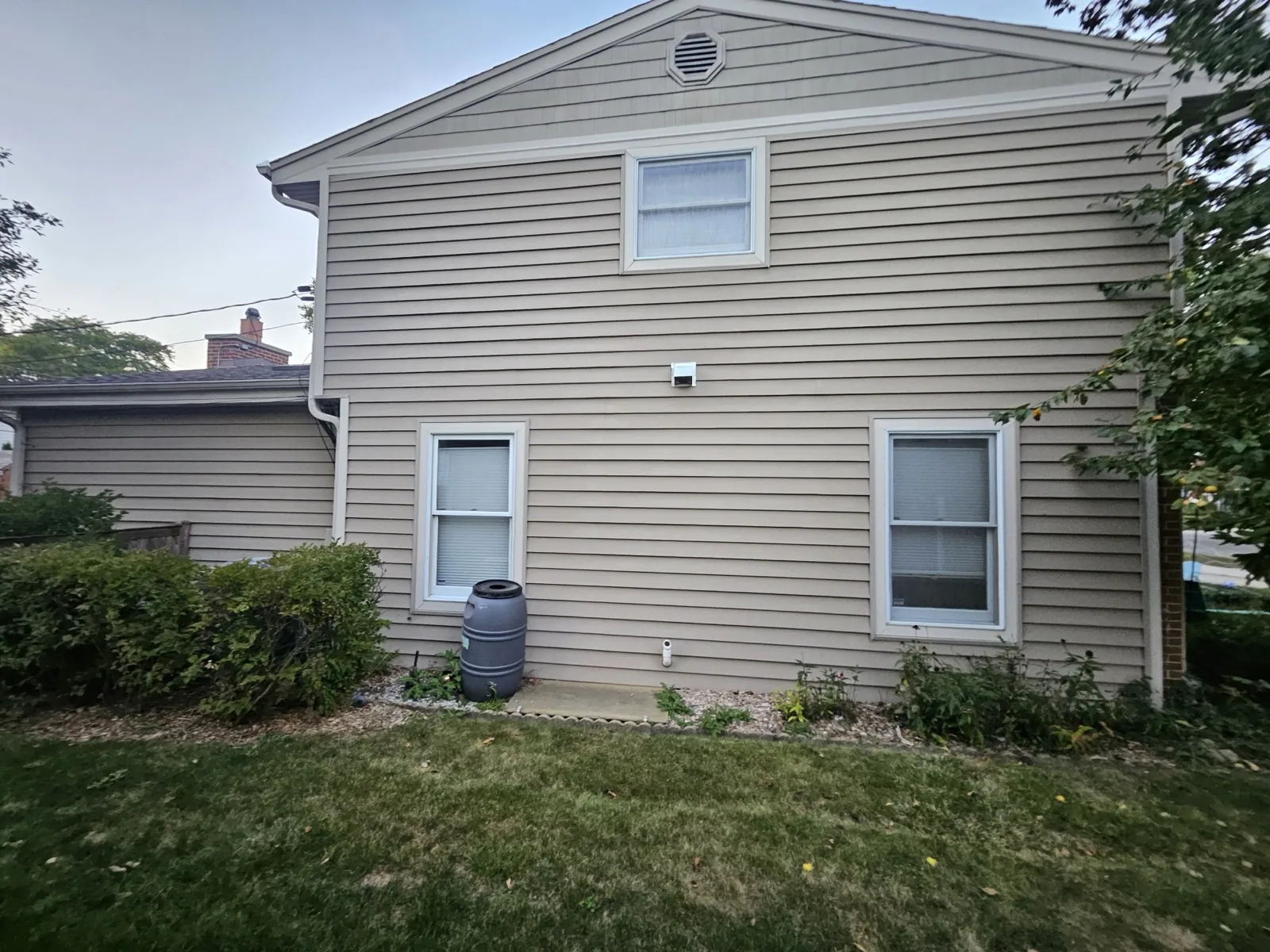 Beige vinyl siding on a two-story home with white trim in Mount Prospect, IL