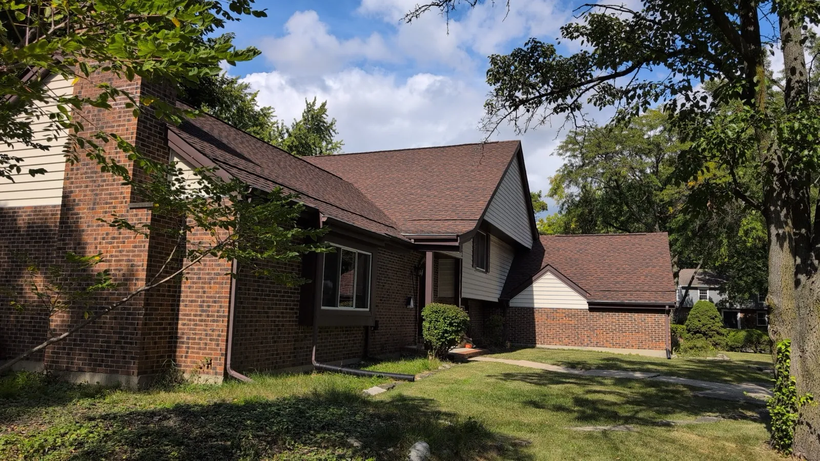 New brown architectural shingle roof on a brick and siding home in Naperville, IL