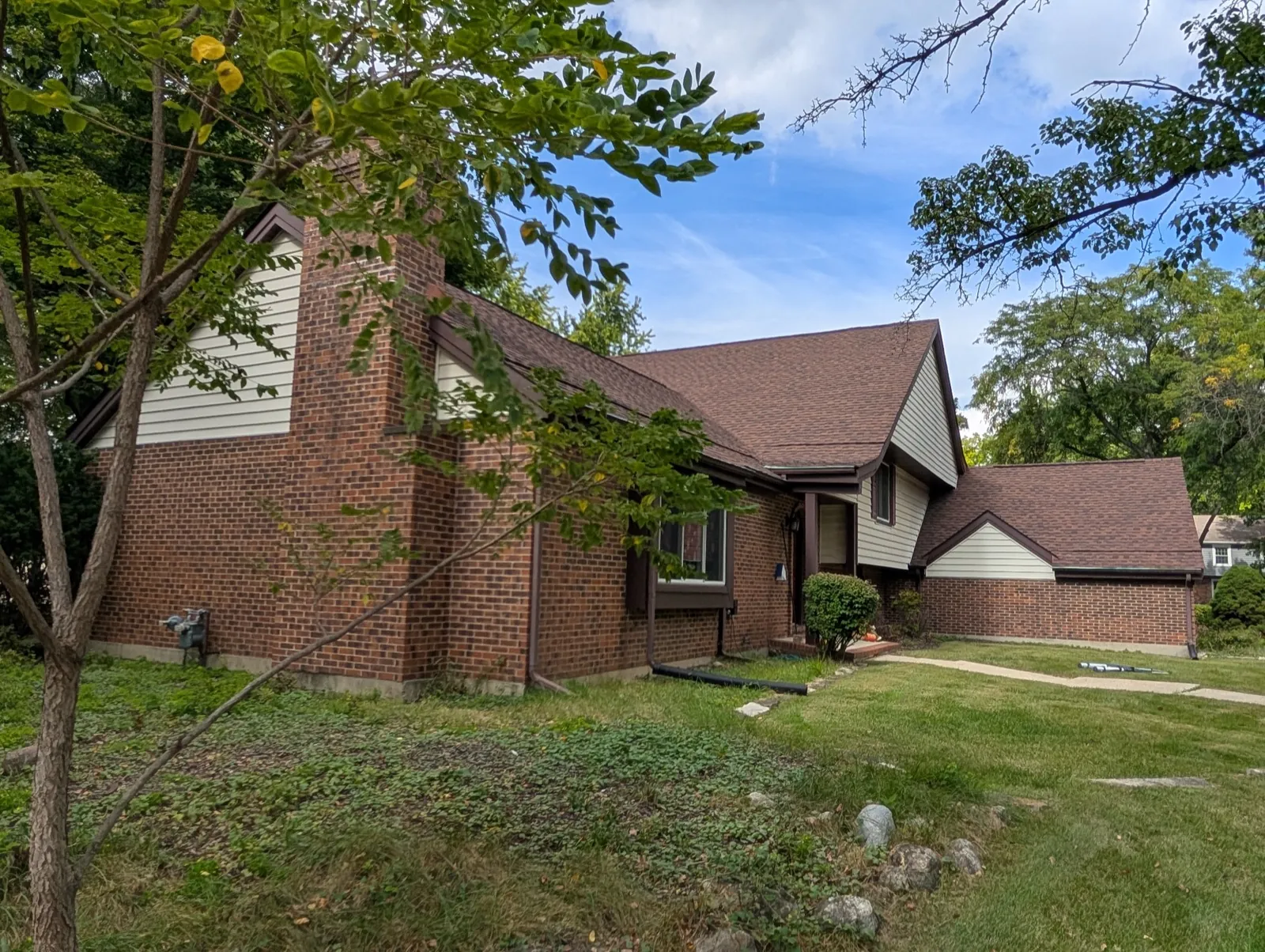 New brown architectural shingle roof on a brick home in Naperville, IL