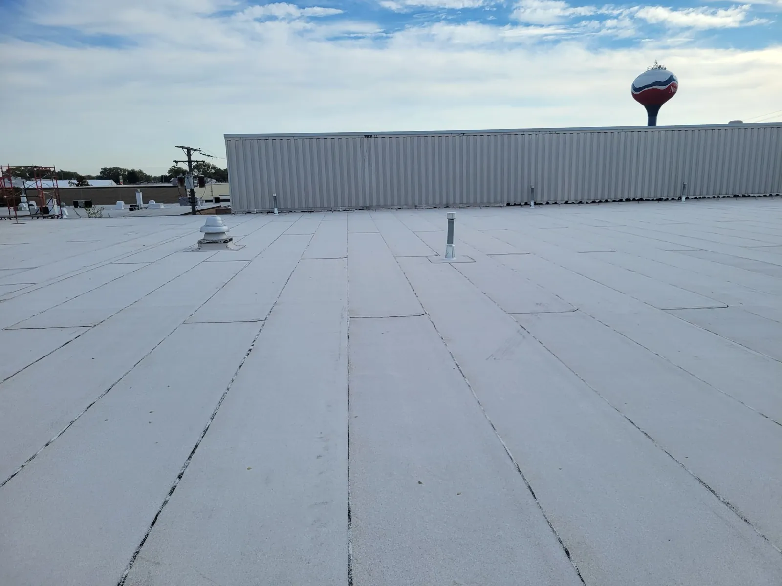 A flat roof with a white membrane surface and various roof vents in Norridge, IL