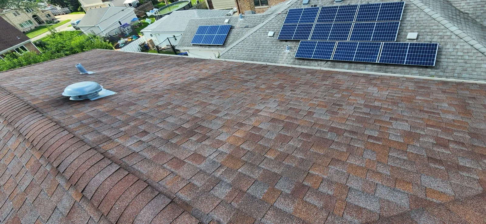 New brown architectural shingle roof with integrated solar panels in Norridge, IL