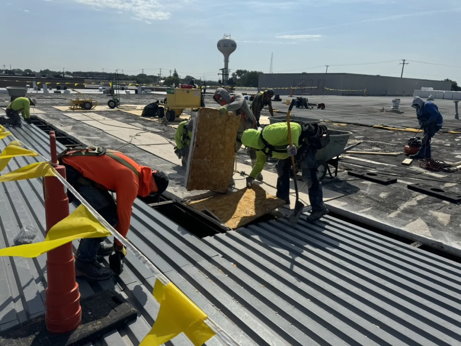 A roofing crew is working on a flat roof installation in Norridge, IL