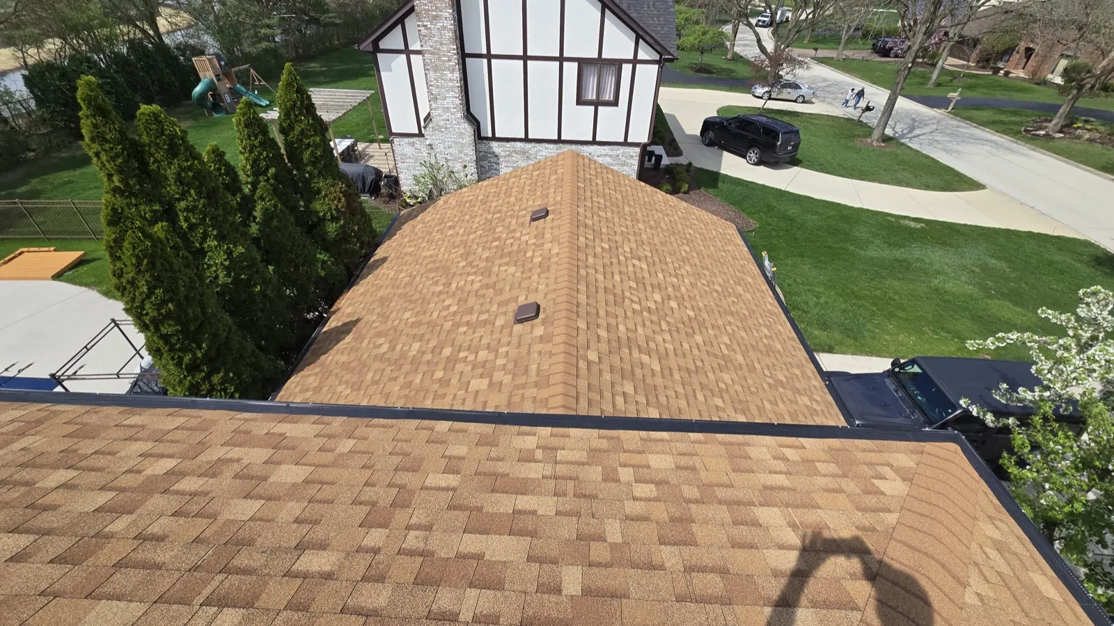 New brown architectural shingle roof on a Tudor-style home in Oak Brook, IL