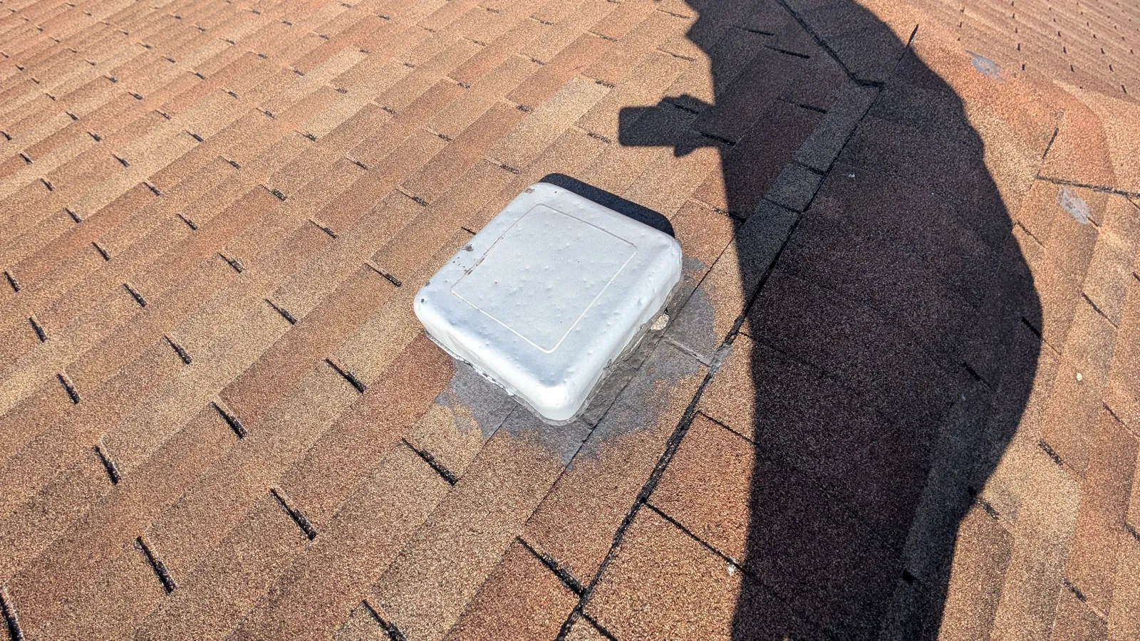 Close-up of a white roof vent installed on a brown asphalt shingle roof in Oak Lawn, IL