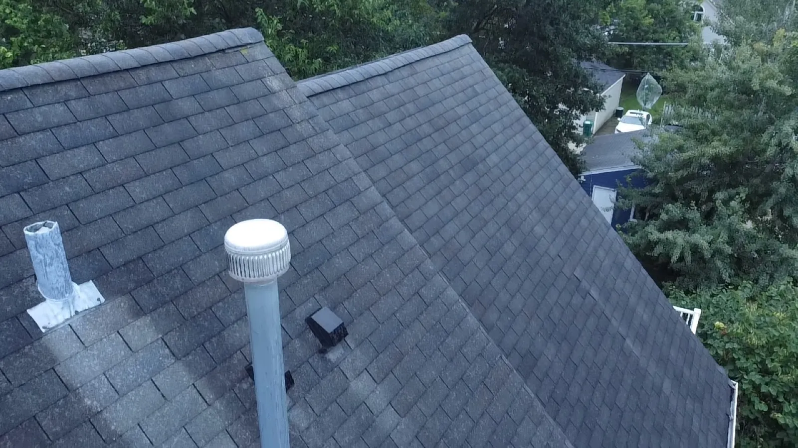 New charcoal gray architectural shingle roof with installed vents in Oak Park, IL