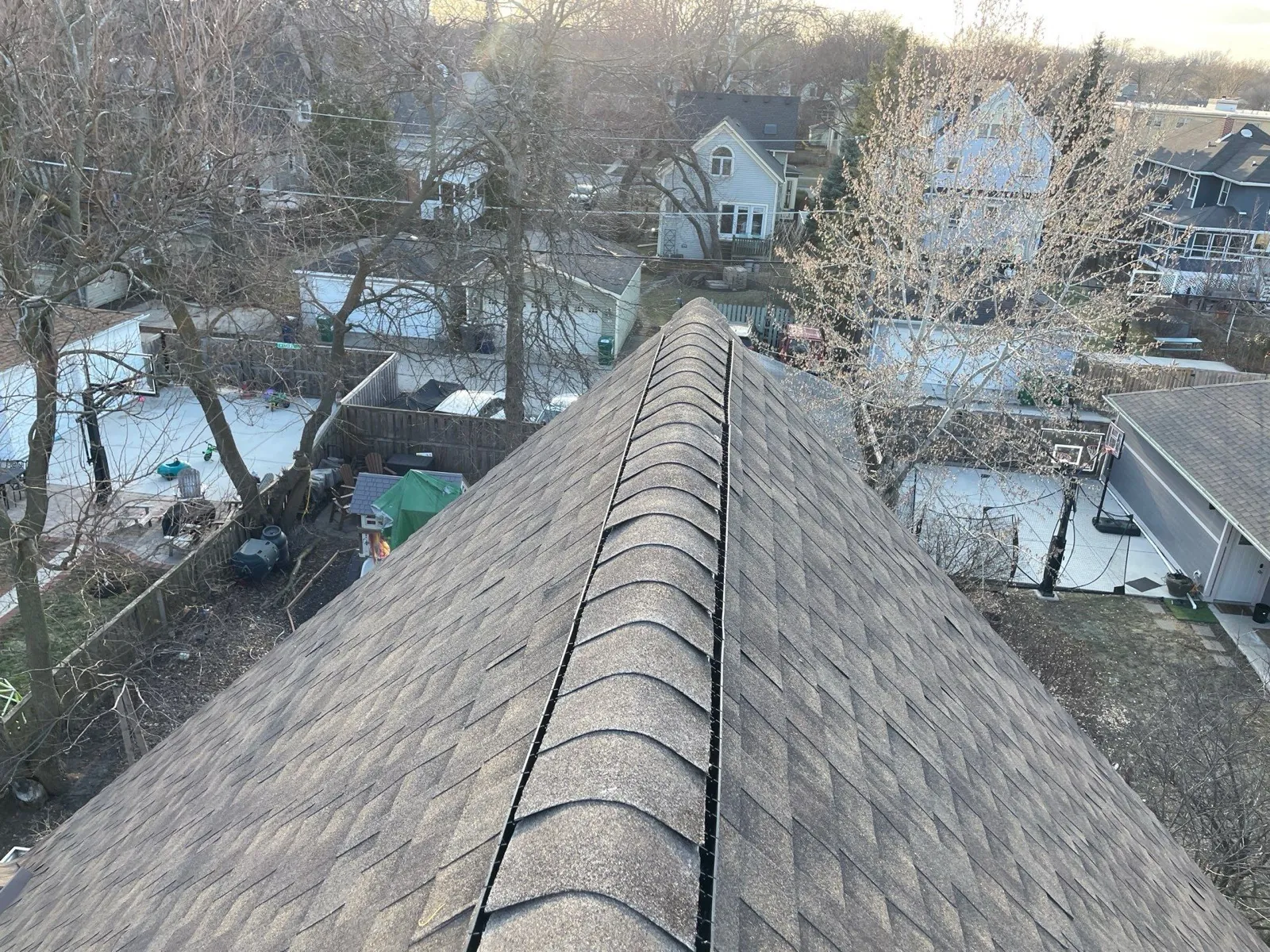 New gray architectural shingle roof with a prominent ridge cap in Oak Park, IL