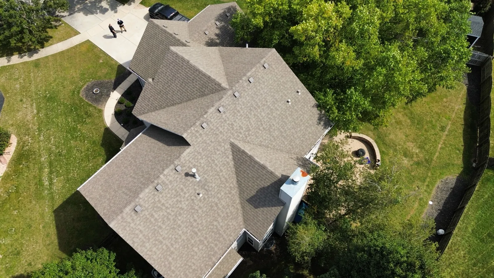 Aerial view of a new brown architectural shingle roof on a large residential home in Oswego, IL