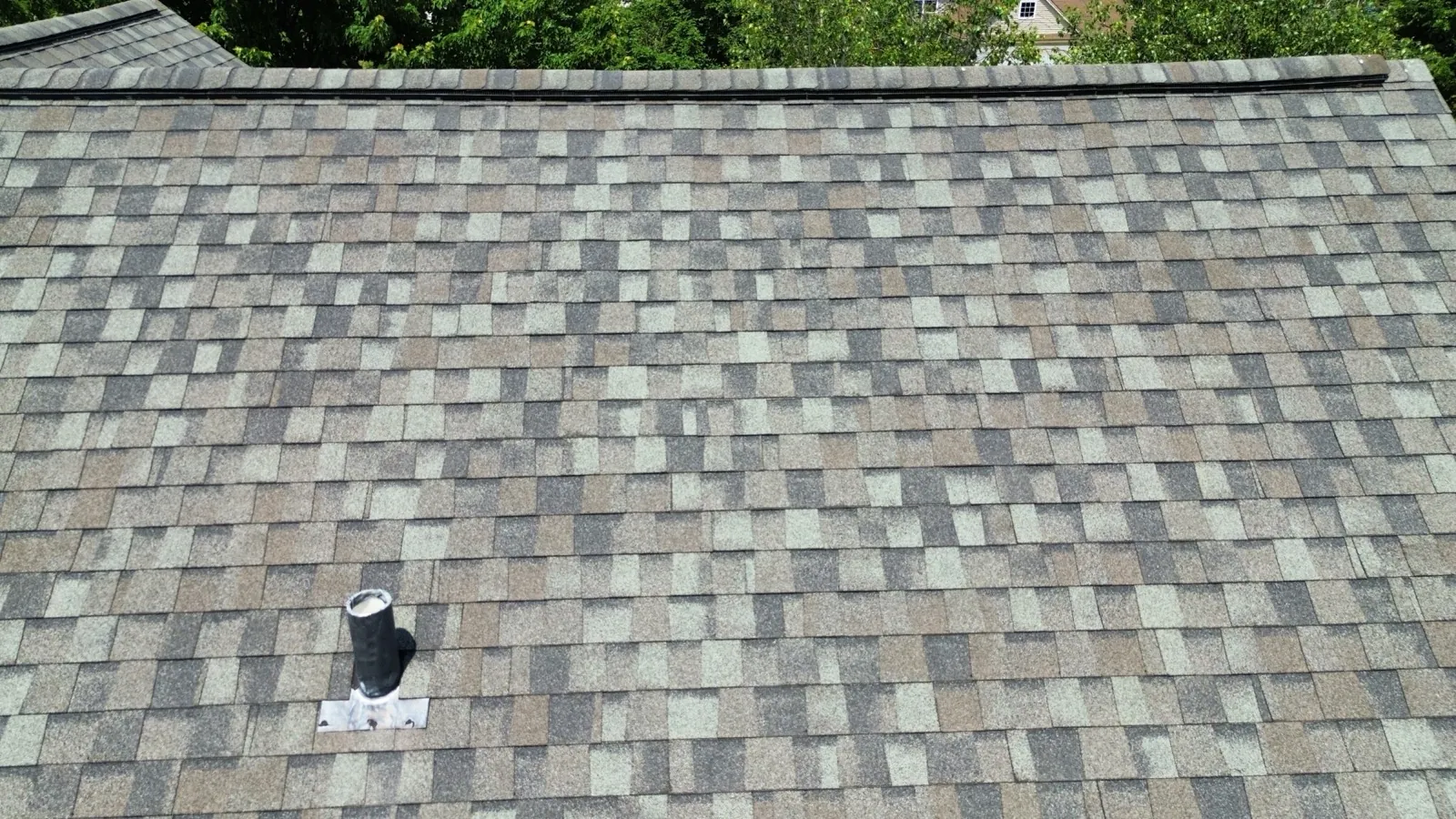New gray and brown architectural shingle roof with a roof vent installation in Oswego, IL