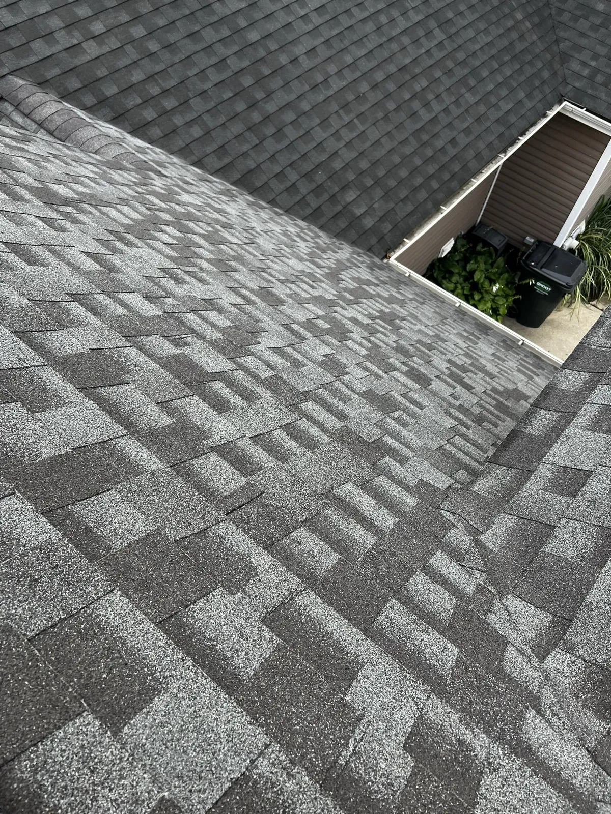 New charcoal gray architectural shingle roof on a multi-level home in Palatine, IL