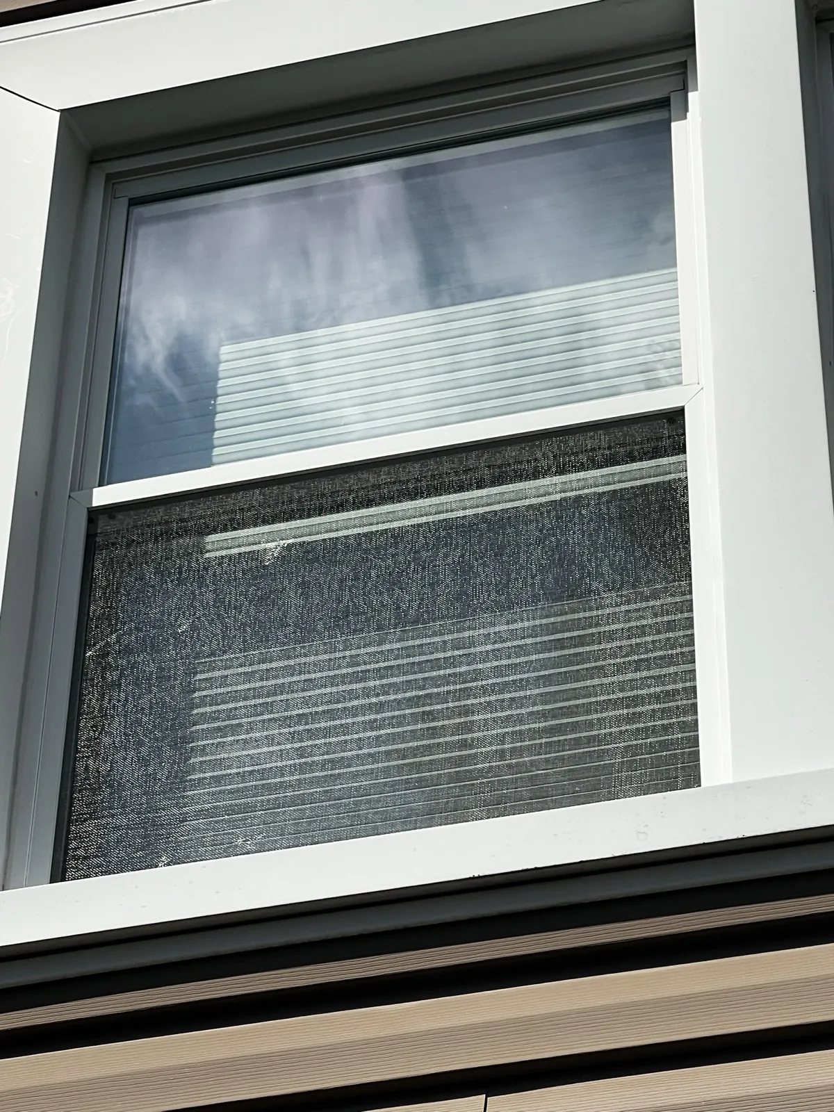A white-framed window with a screen and blinds in Palatine, IL