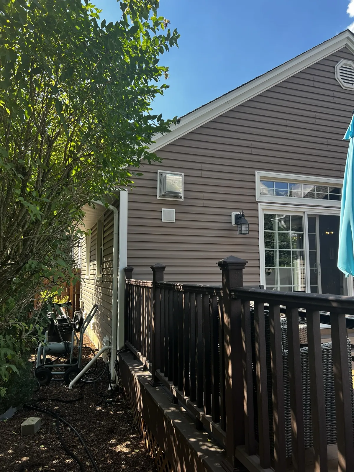 Brown vinyl siding on a residential home with a deck in Palatine, IL