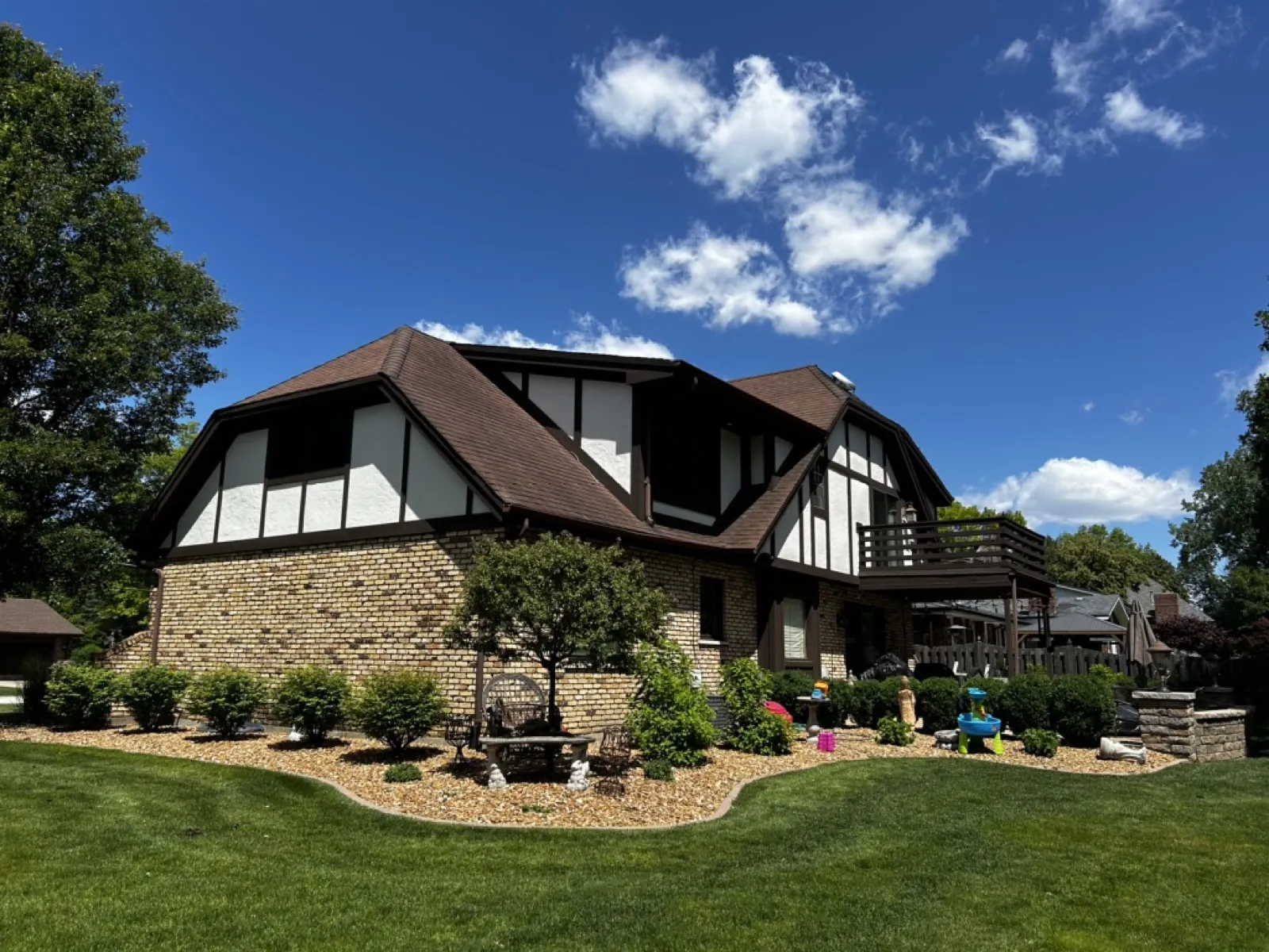 New brown architectural shingle roof on a Tudor-style home in Palos Heights, IL