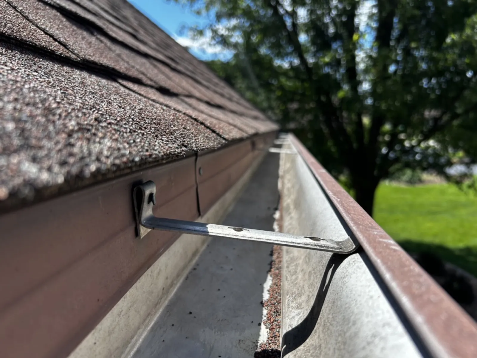 New aluminum gutters installed along the edge of a shingled roof in Palos Heights, IL