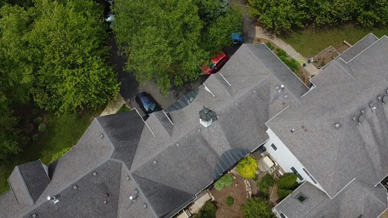 Aerial view of a gray asphalt architectural shingle roof on a large residential home in Palos Park, IL