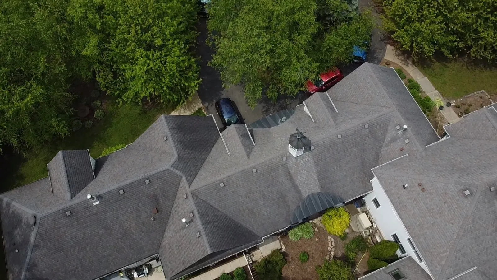 Aerial view of a gray asphalt architectural shingle roof on a large residential home in Palos Park, IL