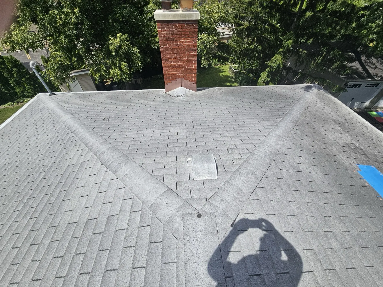 New gray architectural shingle roof with a brick chimney in Park Ridge, IL