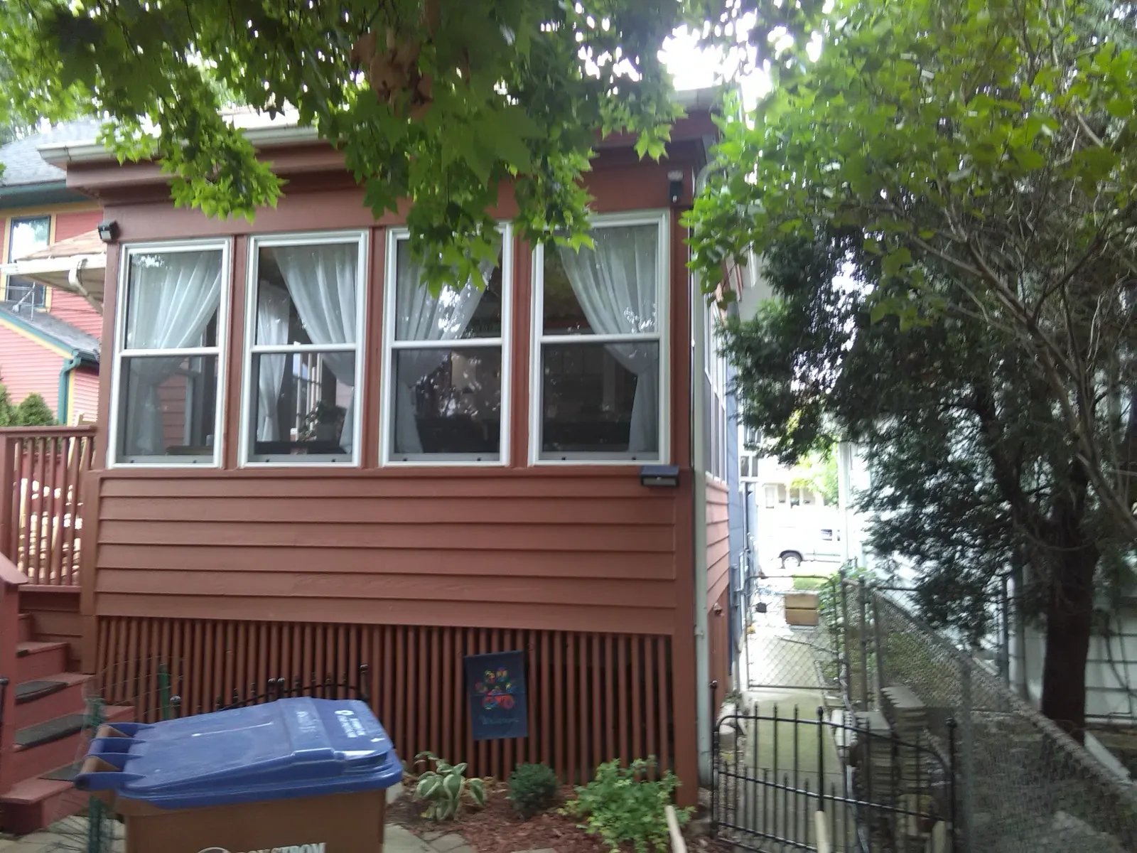 Red vinyl siding on a residential building with large windows in River Forest, IL