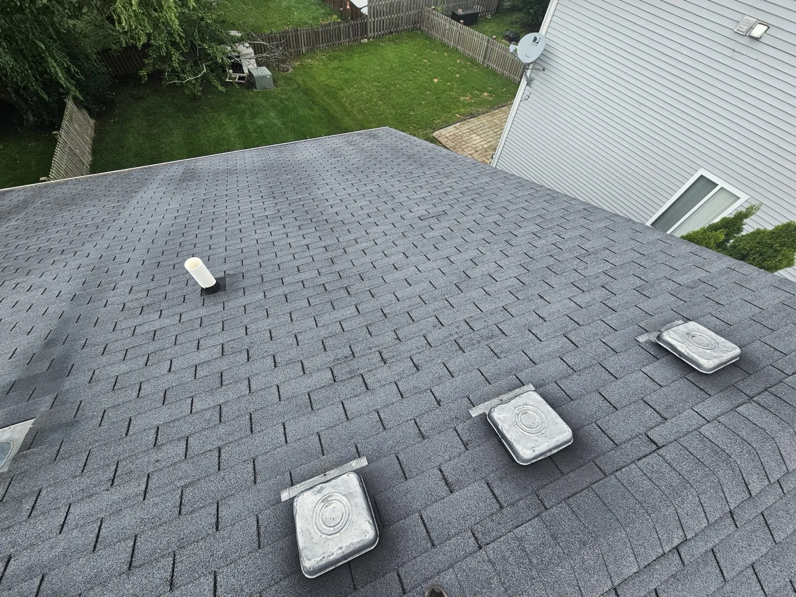 New charcoal gray architectural shingle roof with installed vents in Romeoville, IL