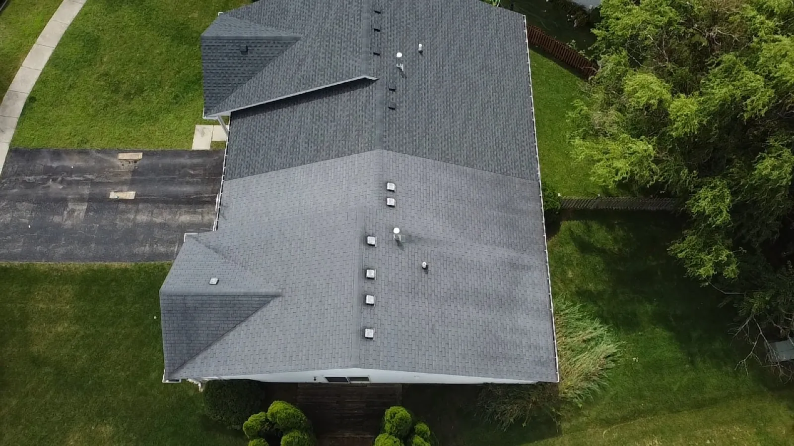 Aerial view of a new charcoal gray architectural shingle roof on a large residential home in Romeoville, IL