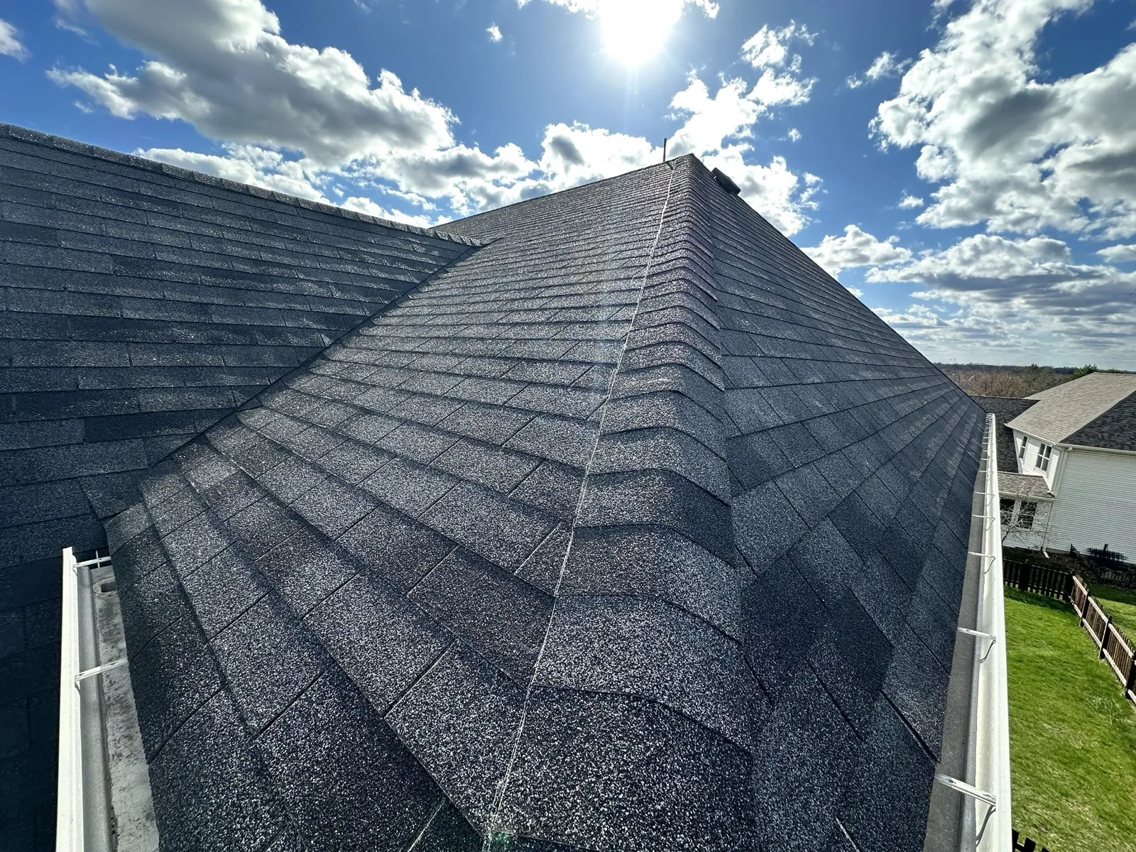 New charcoal gray architectural shingle roof on a multi-gabled home in South Elgin, IL