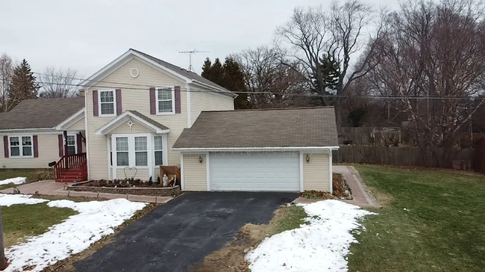 New asphalt architectural shingle roof on a two-story home with an attached garage in St. Charles, IL