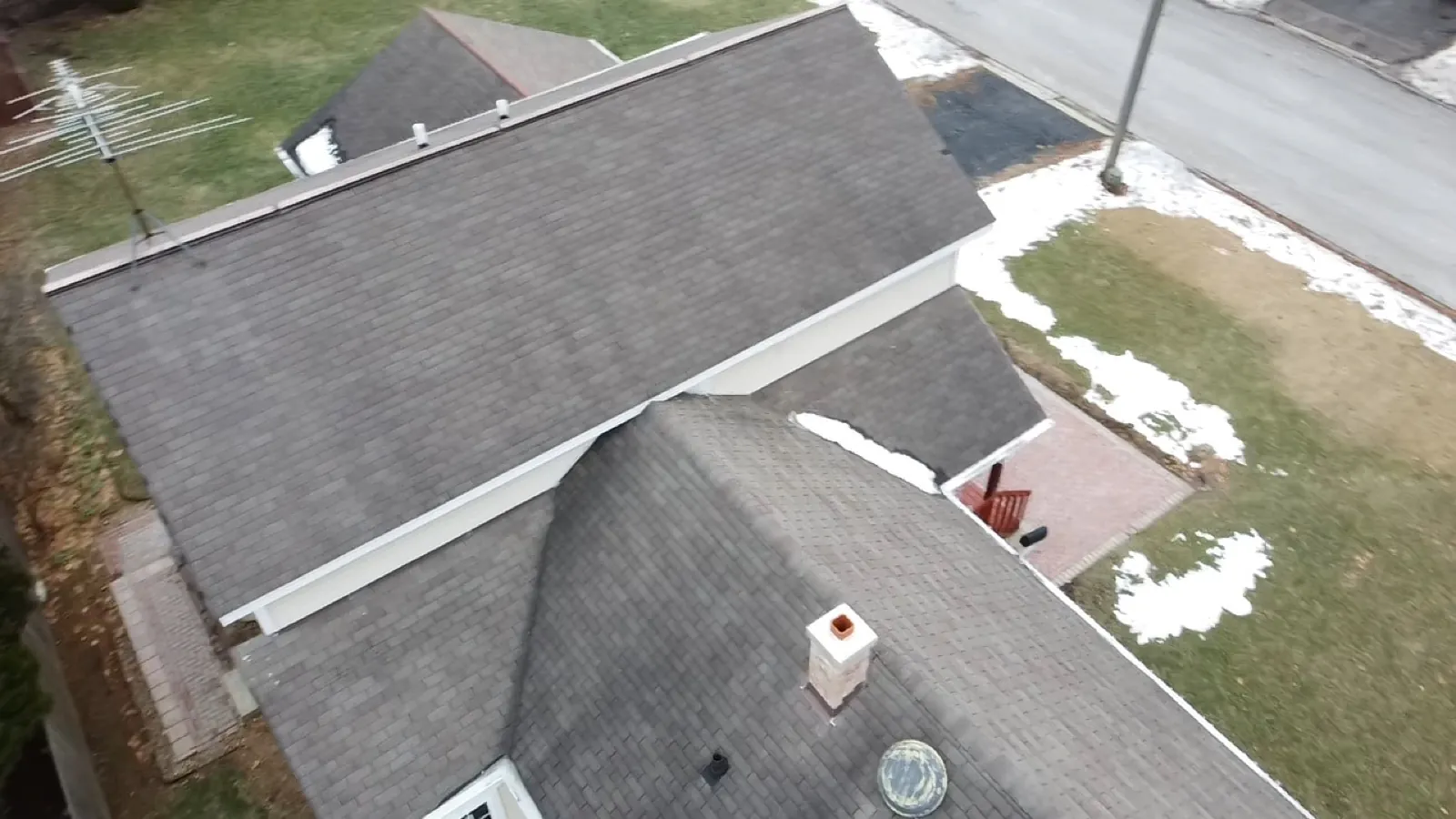 New charcoal gray architectural shingle roof on a multi-level home in St. Charles, IL