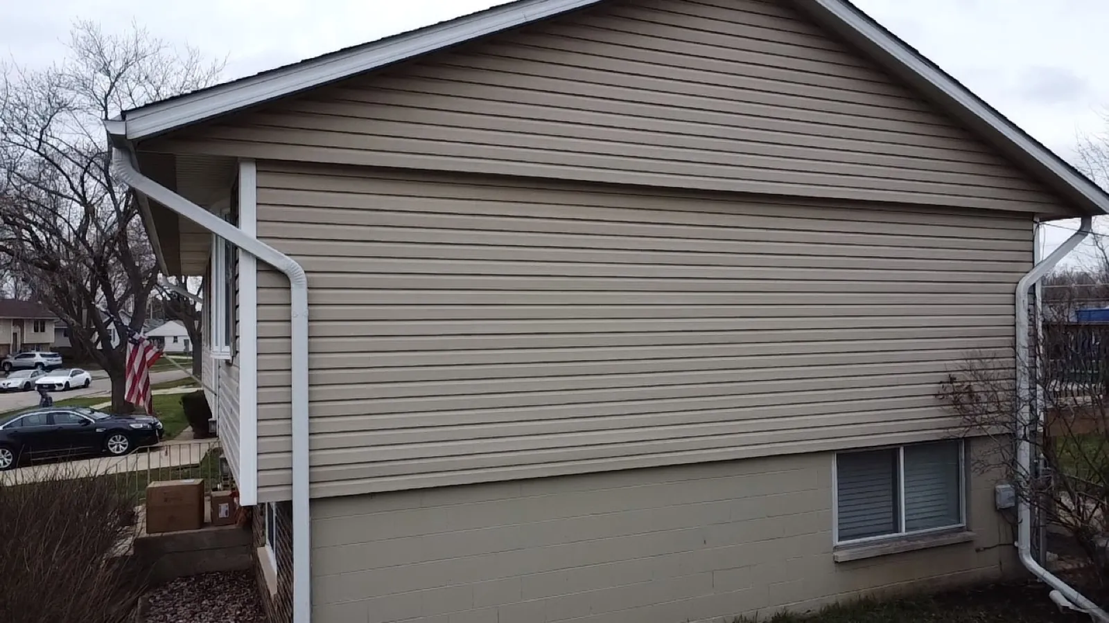 New white gutters and vinyl siding on a residential home in Streamwood, IL
