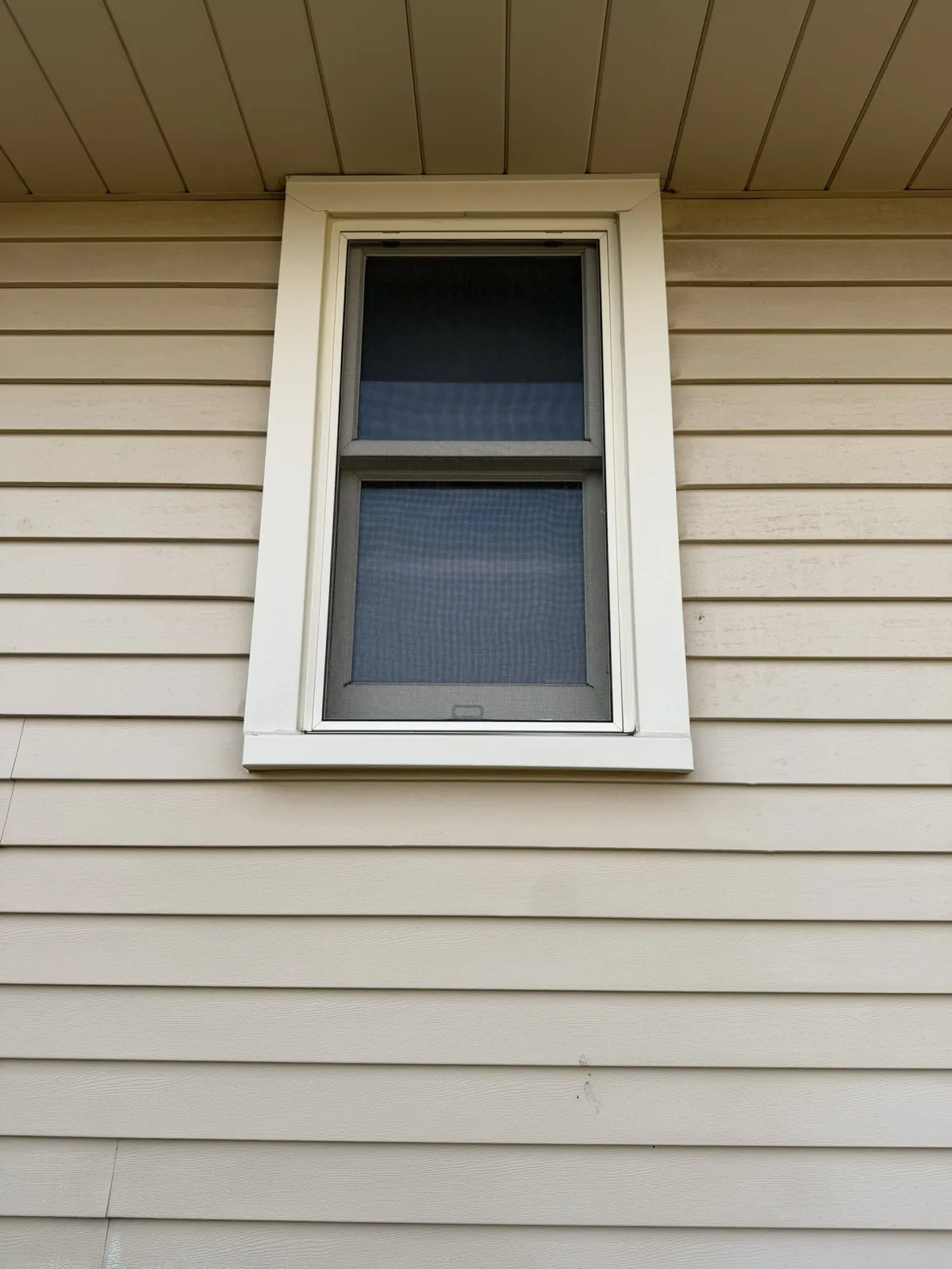 New beige vinyl siding installed on a home exterior in Tinley Park, IL