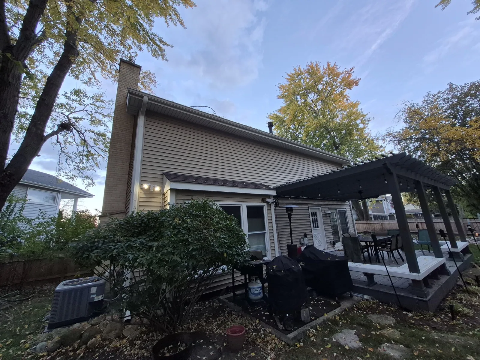 Tan vinyl siding on a residential home with a brick chimney in Vernon Hills, IL