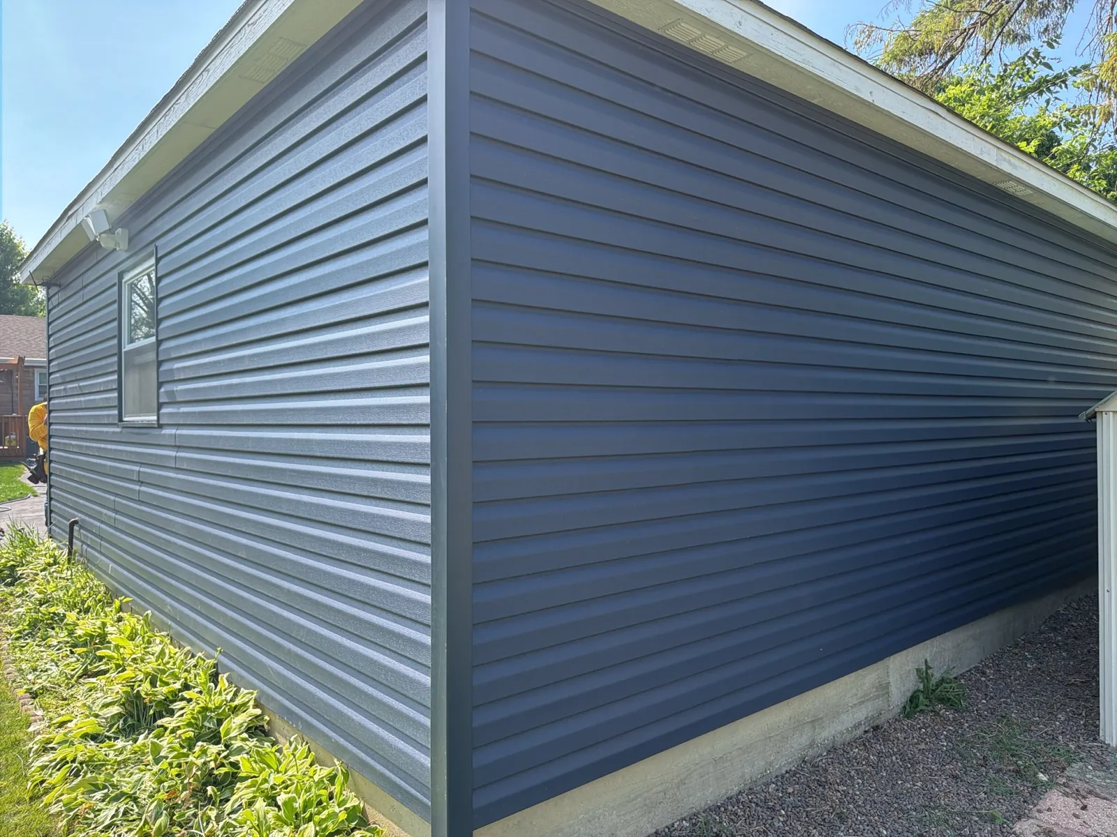 New navy blue vinyl siding installed on a residential building in Villa Park, IL