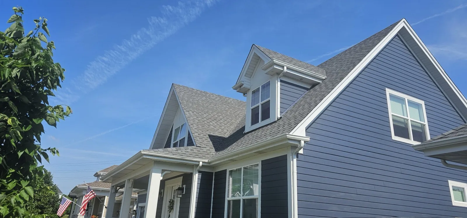 New charcoal architectural shingle roof on a blue siding home in Warrenville, IL