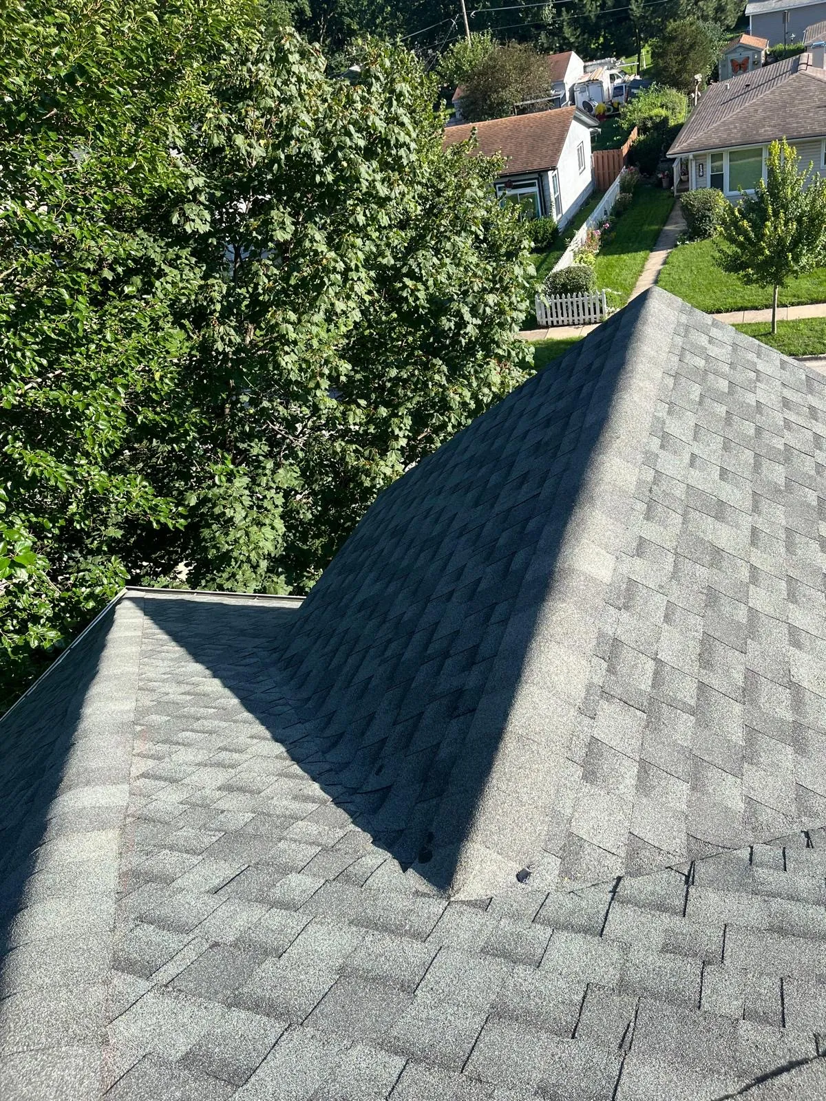 New charcoal gray architectural shingle roof on a home with a prominent dormer in West Chicago, IL