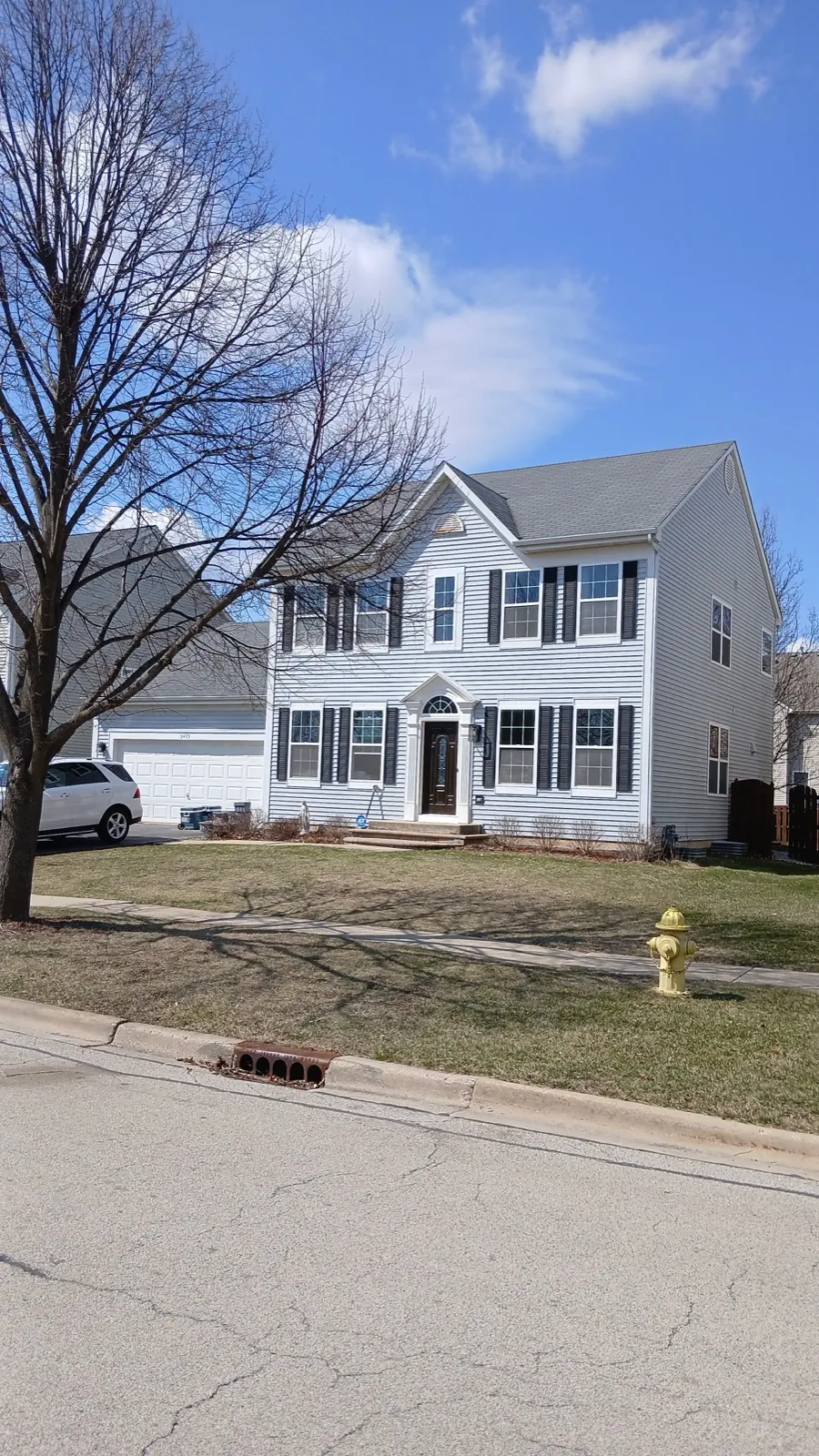 New white vinyl siding on a multi-story residential home in West Chicago, IL