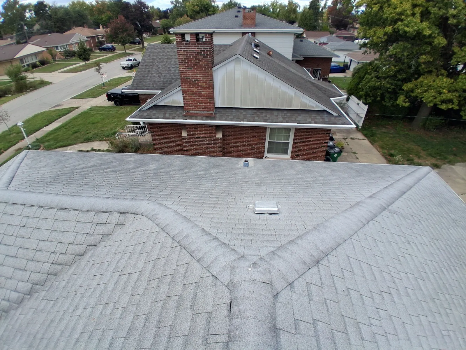 Aerial view of a gray asphalt architectural shingle roof on a residential home in Westchester, IL