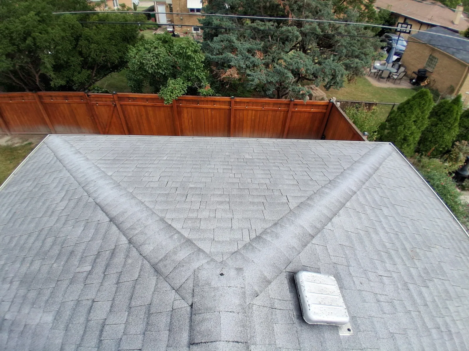 A gray asphalt architectural shingle roof with a prominent hip design in Westchester, IL